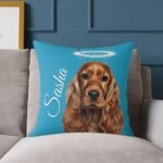 20x20-inch turquoise color custom pet remembrance pillow of dog or cat with halo and pet name, placed on a couch