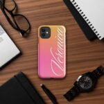 Alt text: Custom phone case with name for her – Style 2, placed on a brown desk. Showcasing a sleek, personalized design with elegant lettering and precise cutouts for a perfect fit.