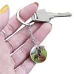 Custom dog portrait keyring in surgical steel. Features a detailed engraved dog portrait on the front with an option for custom engraving on the back. A meaningful keepsake for dog owners