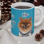 Custom pet photo mug with pet portrait and "Home Is Where My Dog Is" design, turquoise, on a Christmas table