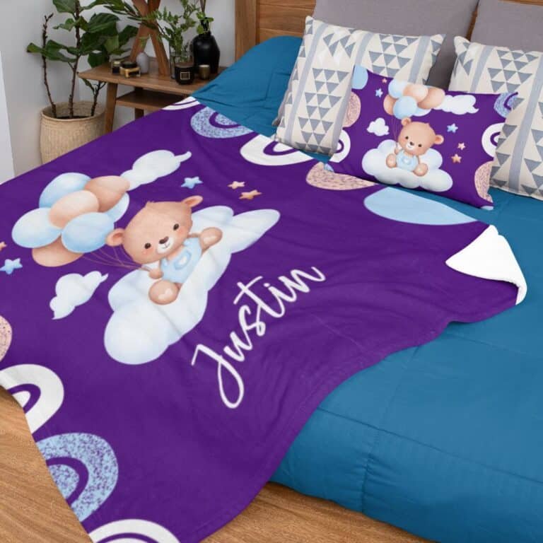Personalized purple baby blanket with a bear and balloons design, customized with the baby’s name, shown in a nursery setting