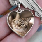 Personalized pet photo keychain in surgical steel, close-up veiw. Features a custom pet portrait engraving on the front with an optional engraved message on the back. A heartfelt keepsake for pet lovers.