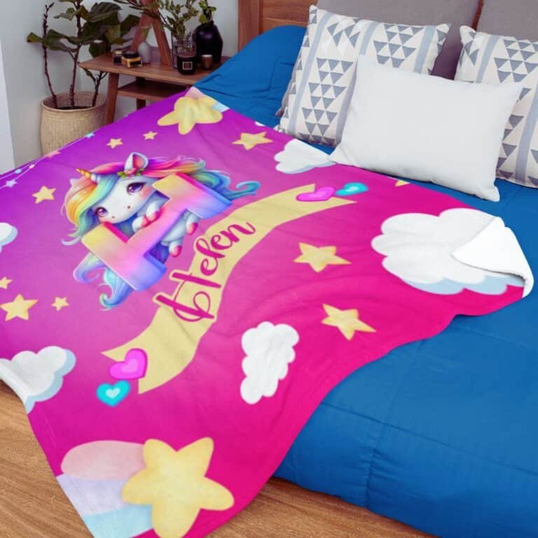 Personalized unicorn blanket for baby girls with name, displayed in a cozy nursery setting.