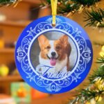 Personalized blue Christmas ornament featuring a pet's photograph.