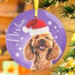 Purple custom dog Christmas ornament featuring a dog wearing a Santa hat