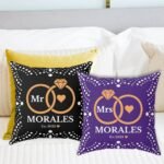 Here’s the corrected version: Black and pillow custom wedding pillows featuring intertwined rings, the couple's last name, and the year of marriage.