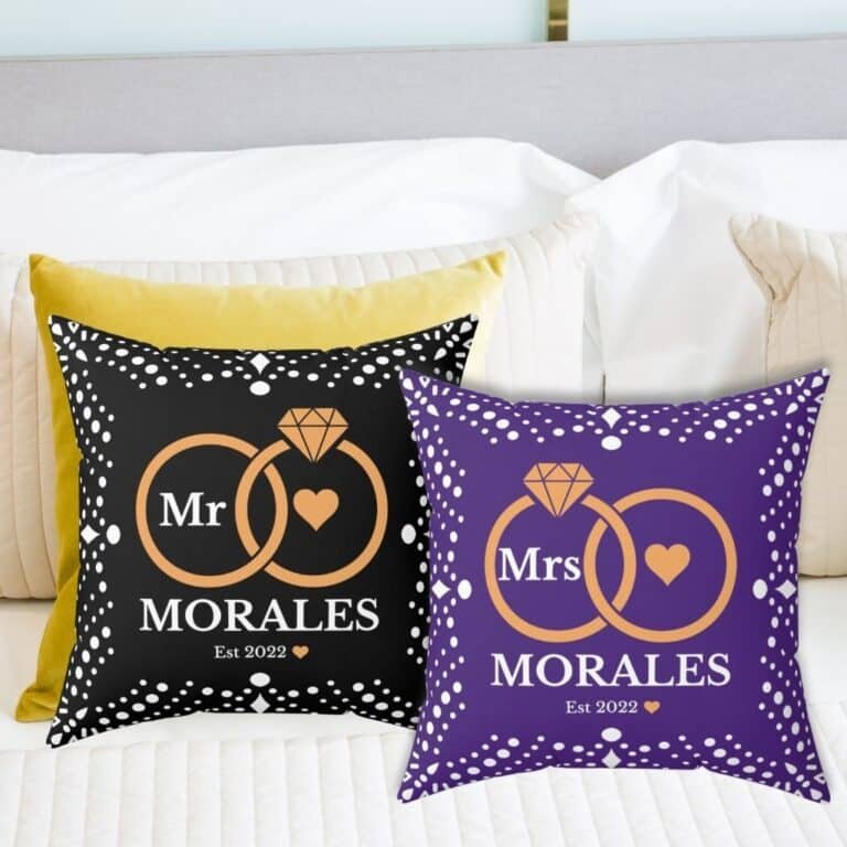 Here’s the corrected version: Black and pillow custom wedding pillows featuring intertwined rings, the couple's last name, and the year of marriage.