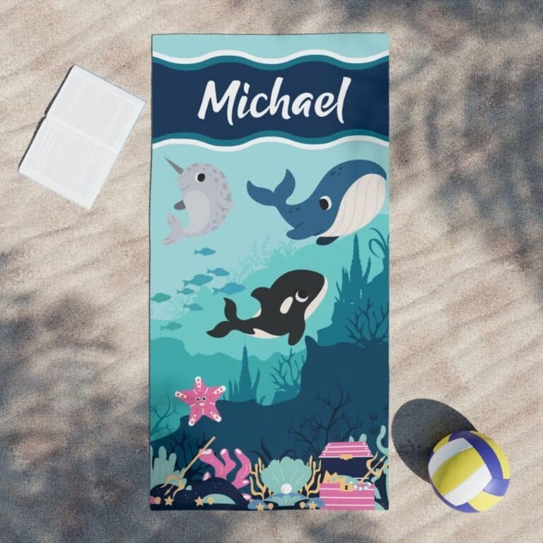 Custom sea world kids beach towel laid out on sand