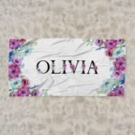 Personalized beach towel with name for her, featuring a floral design in a horizontal layout