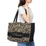 Model holding a golden and black custom name tote bag, showcasing side view and personalized name design
