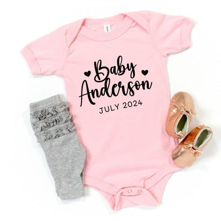 Pink short-sleeve baby bodysuit with "Coming Soon" message, perfect for pregnancy announcements or gender reveals.