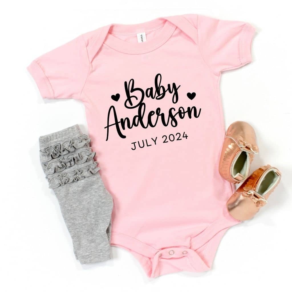 Pink short-sleeve baby bodysuit with "Coming Soon" message, perfect for pregnancy announcements or gender reveals.