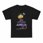 Black birthday girl shirt displayed flat, featuring a gold crown graphic and personalized name printed on the front