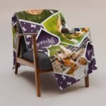 Personalized pet memory photo blanket displayed folded on a chair