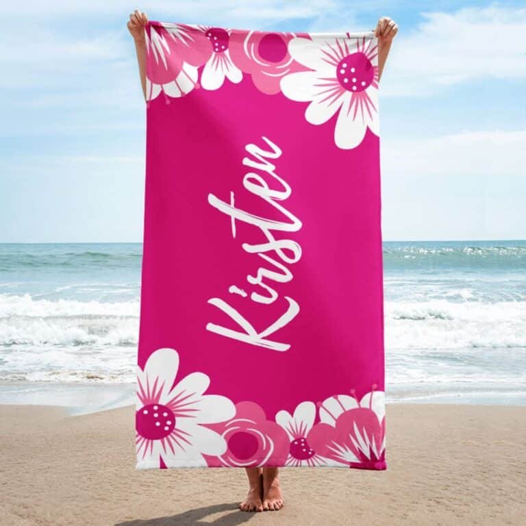 Floral custom towel with name, personalized beach towel for women, displayed on sand with vibrant feminine design