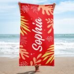 Personalized tropical towel with name for her in Alizarin color – features vibrant tropical leaves and custom name design, ideal for summer, beach, or spa gifts